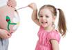 cute kid girl painting mother's belly