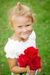 Photo: happy child with a bouquet of red roses happy child with a bouquet of red roses