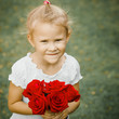 Photo: happy child with a bouquet of red roses happy child with a bouquet of red roses