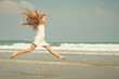 Photo: flying jump beach girl on blue sea shore in summer vacation flying jump beach girl on blue sea shore in summer vacation