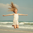 Photo: flying jump beach girl on blue sea shore in summer vacation flying jump beach girl on blue sea shore in summer vacation