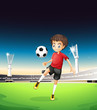 A boy playing soccer alone