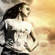 Photo: Beautiful woman over sky background Beautiful woman over sky background