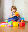 girl plays with toys in home