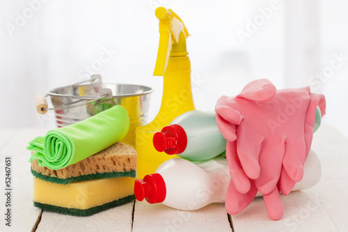 Photo: Bright colorful cleaning set on a wooden table Bright colorful cleaning set on a wooden table