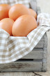 Fresh brown chicken eggs in a crate