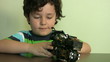 Little boy plays with his  toy motorbike