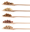 Wooden spoons full of different nuts