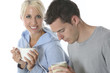 Model Released. Young Couple Relaxing with a Cup of Tea