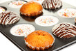 Tasty muffin cakes in baking tray close up