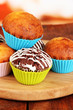Photo: Sweet cupcakes on wooden table Sweet cupcakes on wooden table