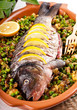 Baked crucian on a pillow from lentil and peas