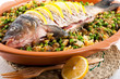 Baked crucian on a pillow from lentil and peas