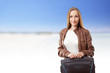 Photo: Woman with a suitcase on the sea beach Woman with a suitcase on the sea beach