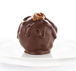 Close up of one large dark chocolate ball on white background