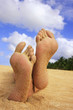 Sandy feet on a tropical beach
