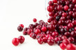 Glass bowl with cranberries on white background