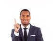 Portrait of happy African American businessman pointing at copy