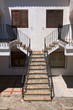 White and symmetrical facade of a house with stairs