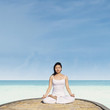 Meditating by lotus position in yoga