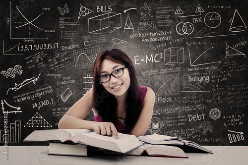 Photo: Happy student and written blackboard Happy student and written blackboard