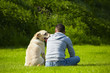 Young man with his dog on meadow