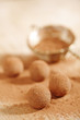 chocolate truffles cocoa powder dusted and sieve, shallow dof