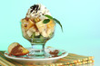 Fruit salad in a sundae dish on a blue background