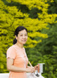 Mature woman preparing to paint outdoor deck railing
