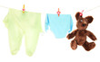 Baby clothes hanging on clothesline, isolated on white
