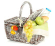 Picnic basket with fruits and bottle of milk, isolated on white