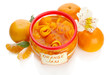 Orange jam with zest and tangerines, isolated on white