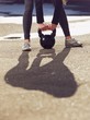 Photo: Kettlebell Being Lifted by Fitness Woman Kettlebell Being Lifted by Fitness Woman