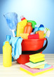 Cleaning items in bucket on  color background