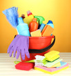Cleaning items in bucket on  color background
