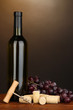 Wine and corks on wooden table on brown background