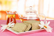 Tasty halva with tea on table in room