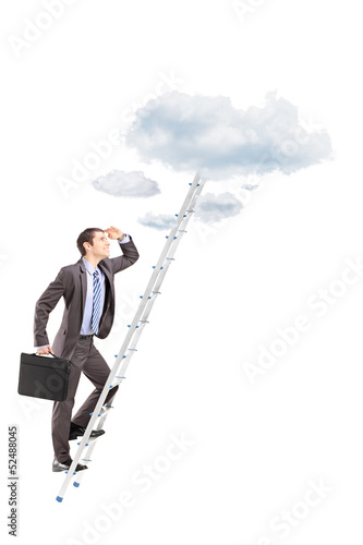 Photo: Full length portrait of a businessman with briefcase climbing a Full length portrait of a businessman with briefcase climbing a