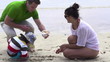 Family on beach with beautiful seashell, super slow motion