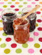 Tasty jam in banks on table