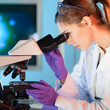 Health care professional microscoping.
