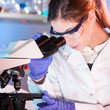 Health care professional microscoping in the laboratory.