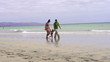 Happy family walking on the beach, super slow motion