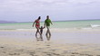 Happy family walking on the beach, super slow motion
