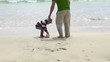 Father and son find beautiful seashell, super slow motion