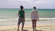 Young girlfriends walking on the beach, super slow motion