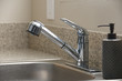 Empty clean kitchen sink and soap dispenser