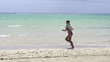 Woman jogging on beautiful beach, super slow motion