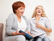 Foto: Mother and daughter looking photo book Mother and daughter looking photo book