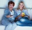 Foto: Mother with adult daughter watching television Mother with adult daughter watching television